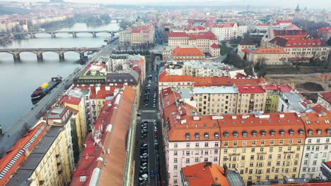 drone aerial view of prague, czech republic, downtown buildings by vltava river and famous bridges on misty morning, drone shot