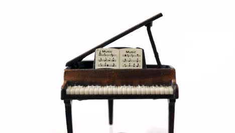 metal grand piano music toy rotating around in studio white background