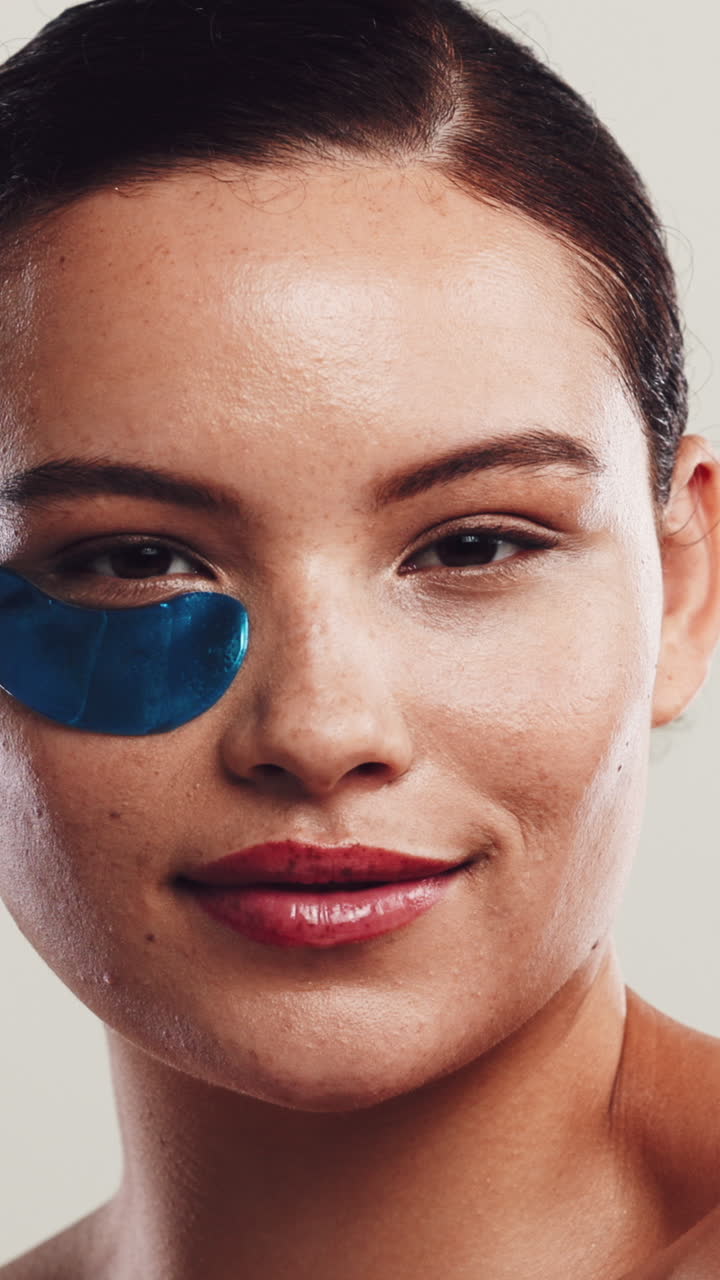 Young Woman Applying Blue Under Eye Patches for Skincare