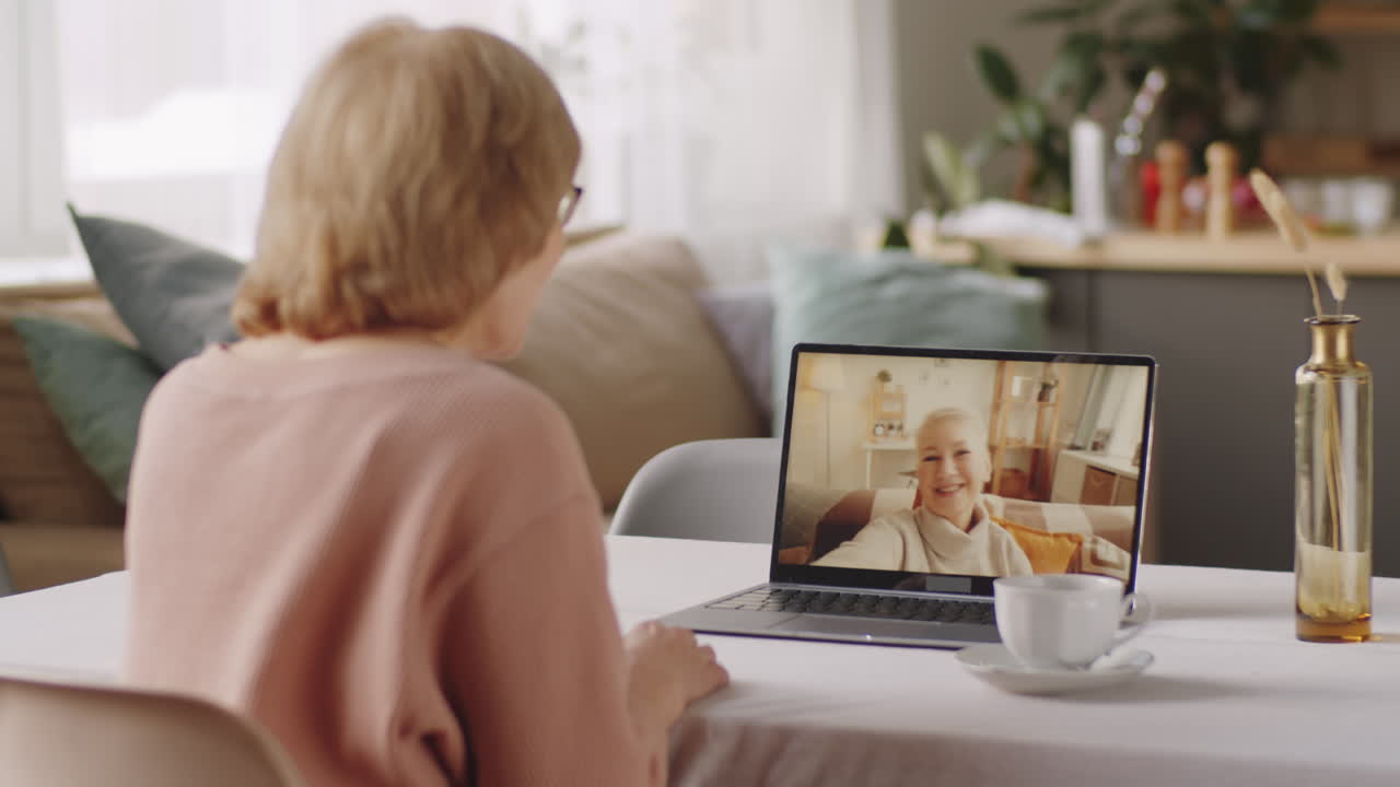 Elderly Woman Chatting with Female Friend on Video Call