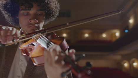 african american musician playing fiddle on stage