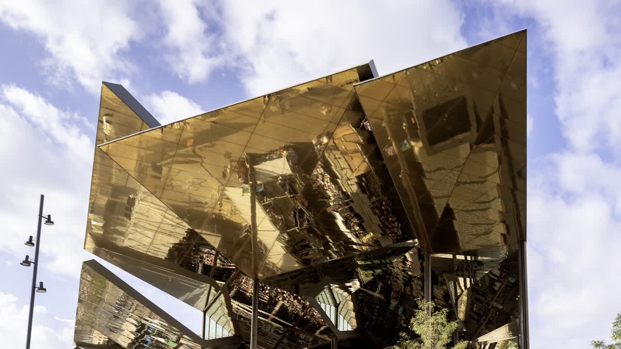 Timelapse of the encants second hand market with gloden reflecting roof in barcelona