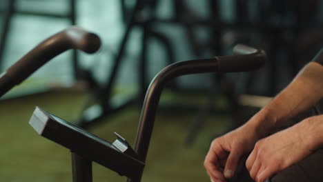 unknown man exercising in fitness center. male person warming up at gym