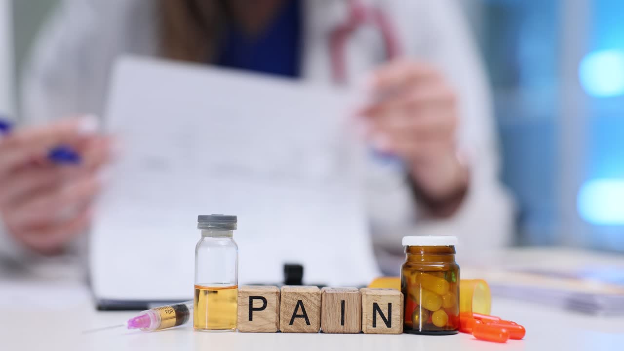 Medical Supplies and 'PAIN' Blocks on Doctor's Desk