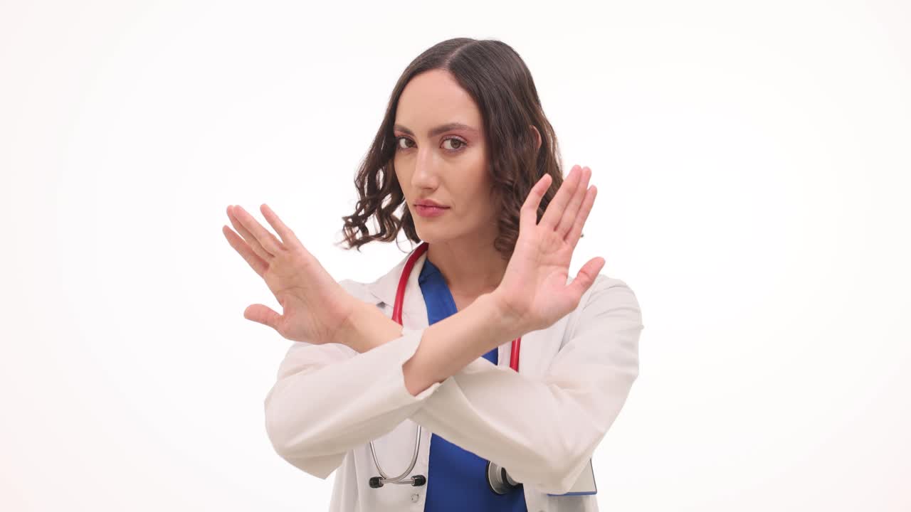 Female Doctor Gesturing 'Stop' and Pointing