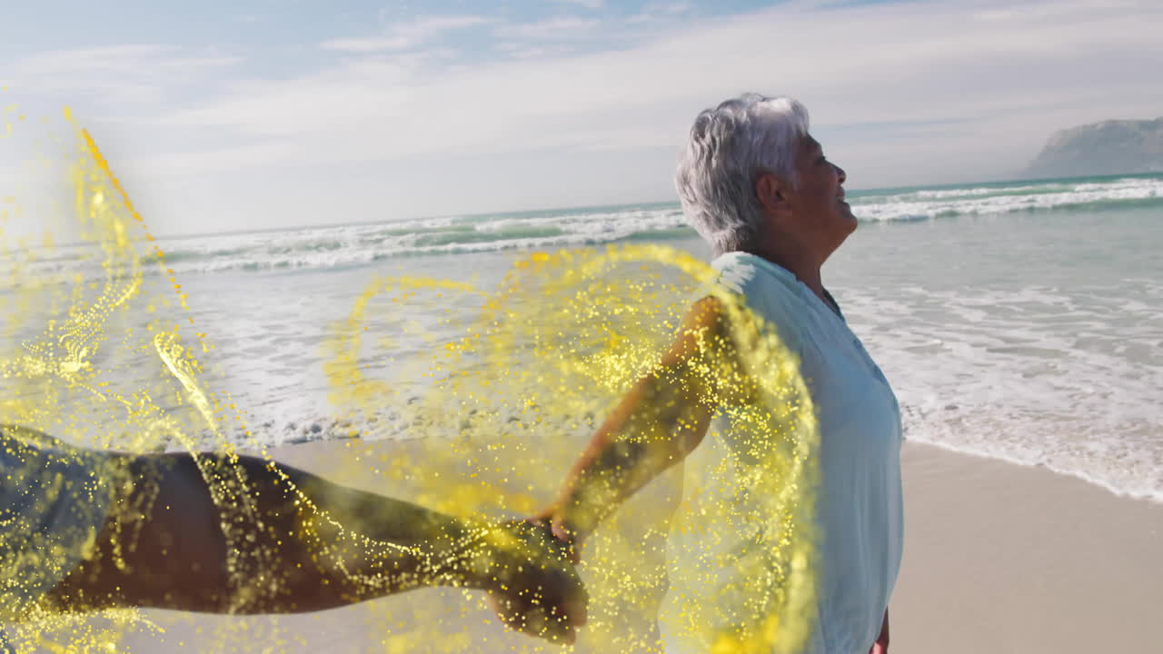 Senior woman walking on beach, holding partner's hand in health ad, with golden particles swirling