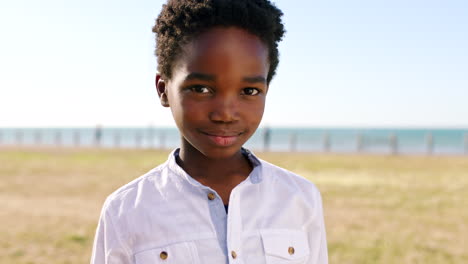 black child, face and smile at a beach park