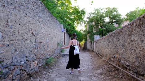 tourist,-girl,-walking,-abandoned-village,-exploration,-adventure,-travel,-kayaköy-in-turkey-fethiye