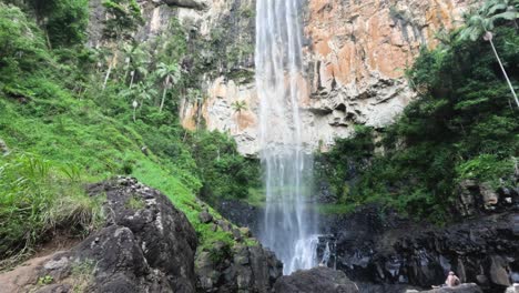 tall waterfall cascading down rocky cliff