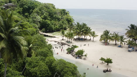 Idyllic-Beach-With-Tourists-Enjoying-During-Summer-Vacation-At-Playa-Rincon,-Dominican-Republic---aerial-drone-shot