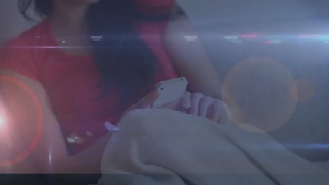 animation of data processing and lights over asian woman using smartphone