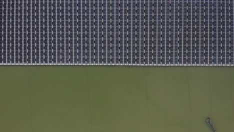 aerial view of floating solar panels in a small pond
