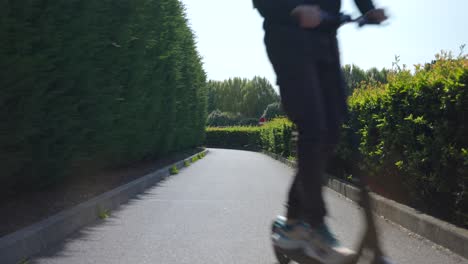 portrait of a man riding an electric scooter with protective helmet for safety