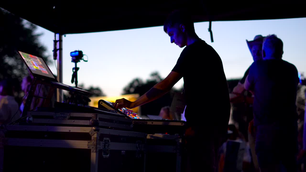 Tired DJ sound mixing at the event. Lithuania, Rusne Festival.