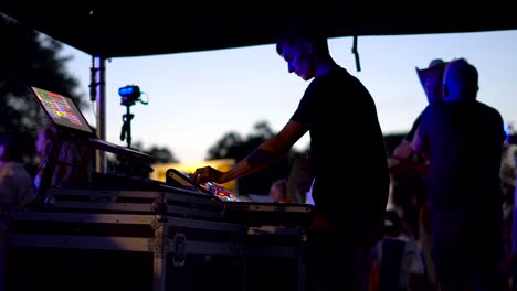 tired dj sound mixing at the event. lithuania, rusne festival.