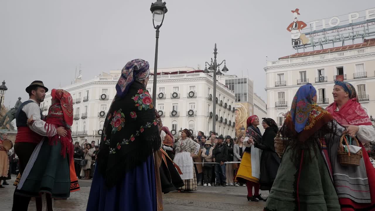 Traditional dance of people in Madrid at the trashumancia festival in spanish dresses, people watching at plaza de sol, copy space, static shot