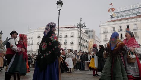 traditional dance of people in madrid at the trashumancia festival in spanish dresses, people watching at plaza de sol, copy space, static shot