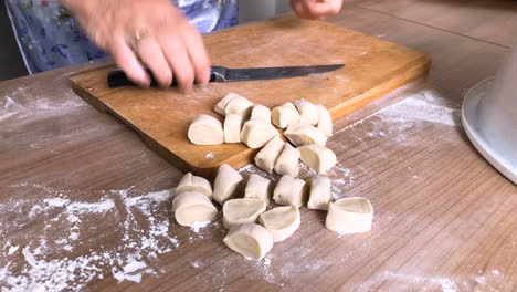 The-woman-cuts-dough-into-slices