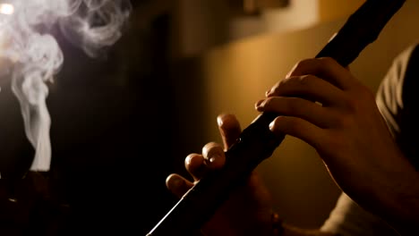 man playing japanese bamboo flute - shakuhachi
