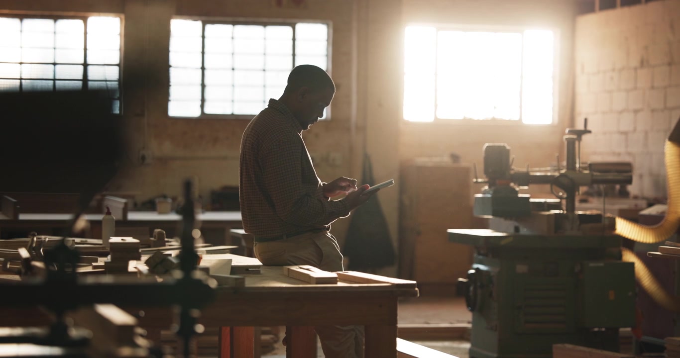 Carpenter Using Digital Tablet in Woodworking Workshop