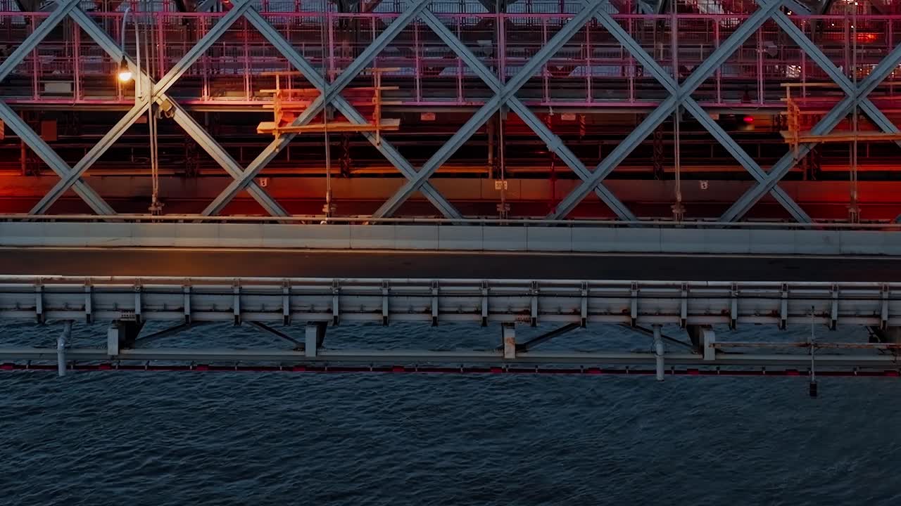 Moving car lights on bridge deck at blue hour