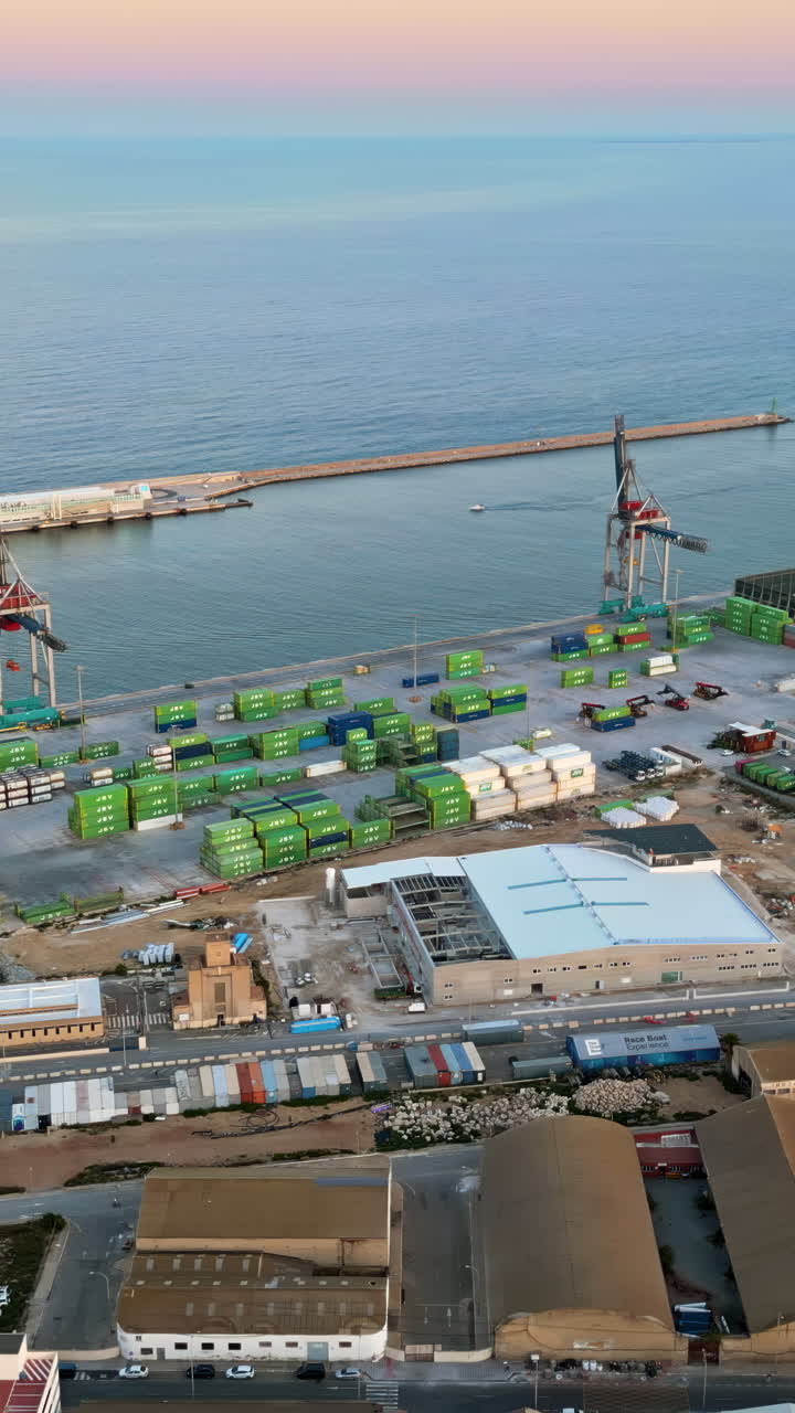 Aerial drone view of a Cargo terminal in Alicante, Spain at sunset. Vertical