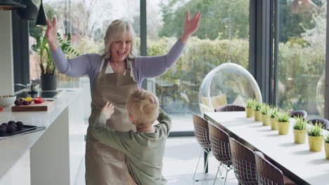 a grandmother and her grandchild share a happy moment in the kitchen