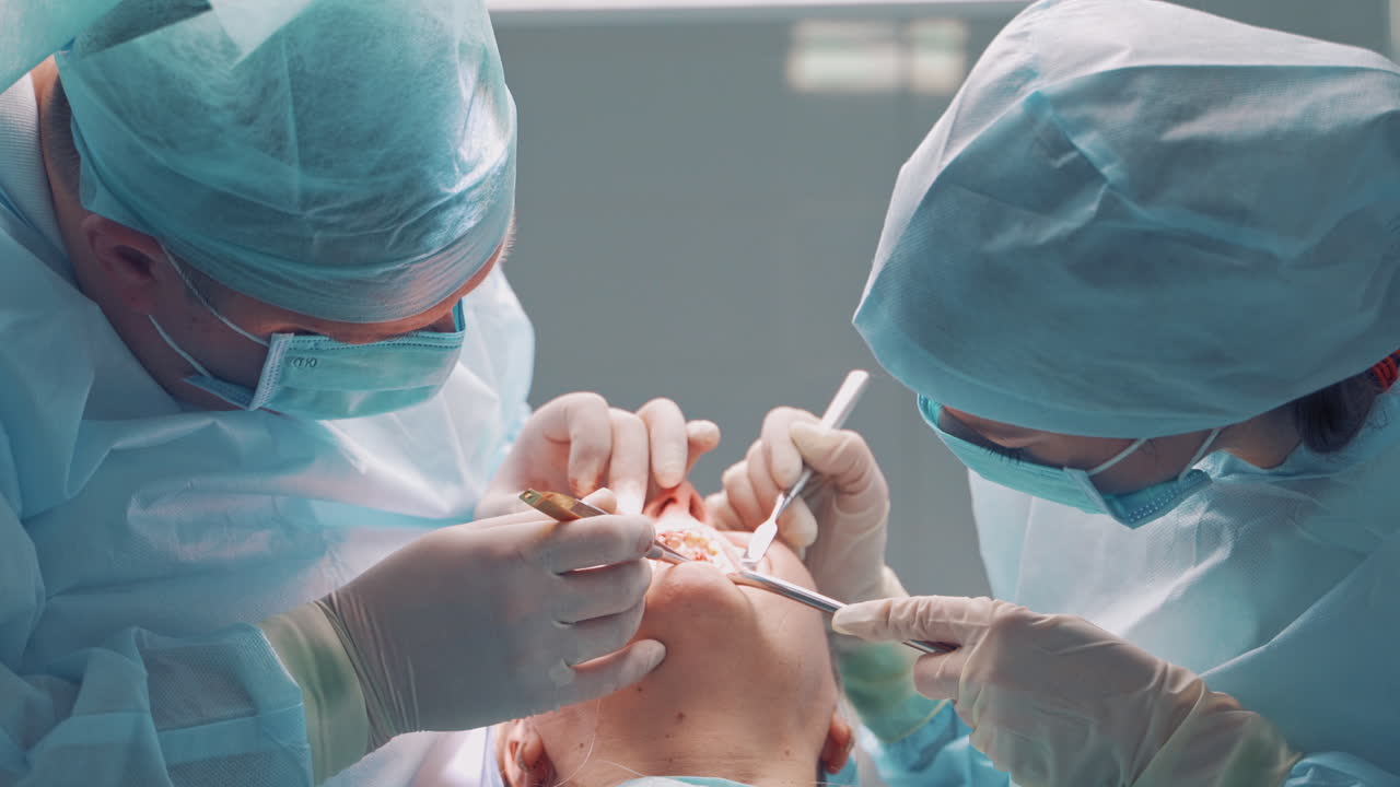 Dental implant surgery. Dentists during surgery for implant placement