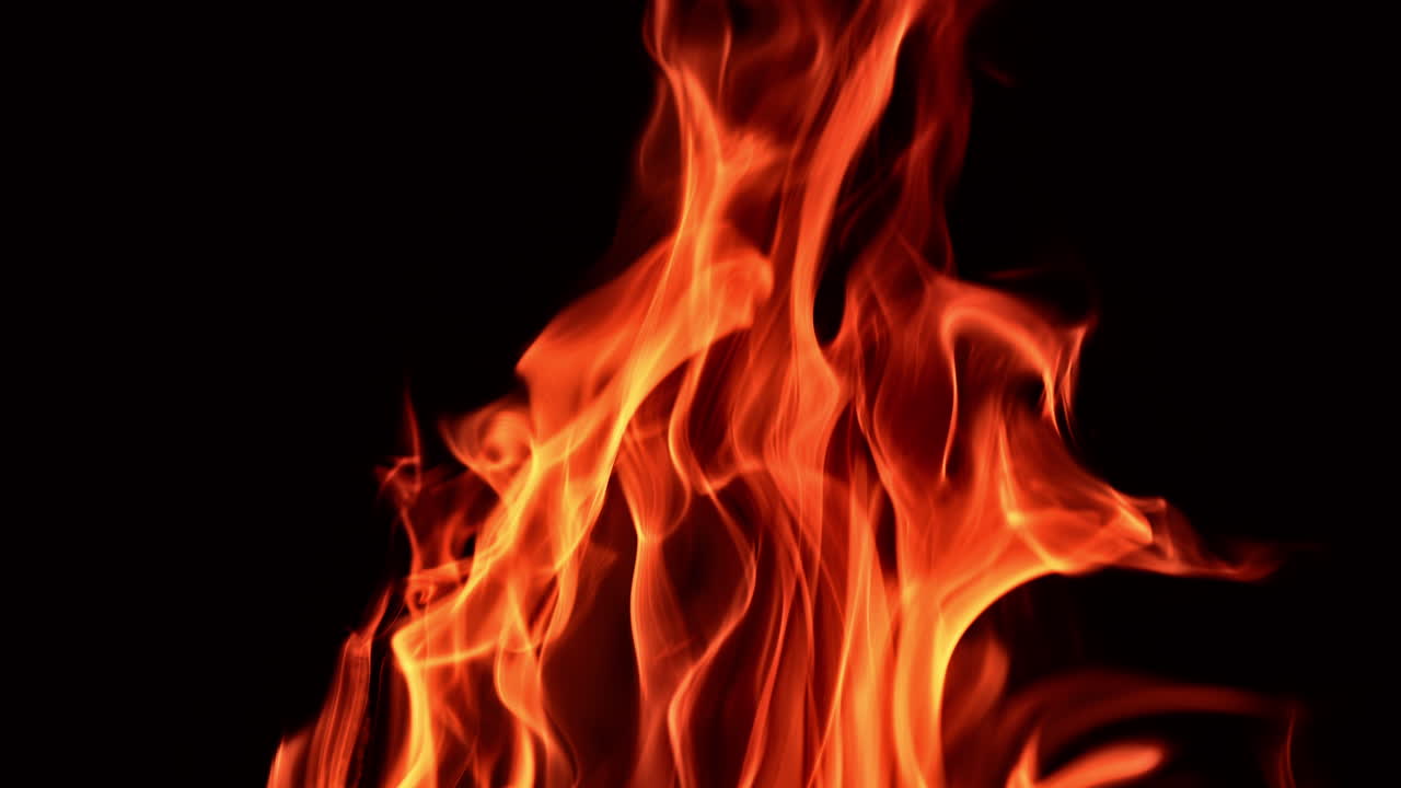 Beautiful red and orange flames of burning fire. Blaze isolated at black backdrop. Close up.