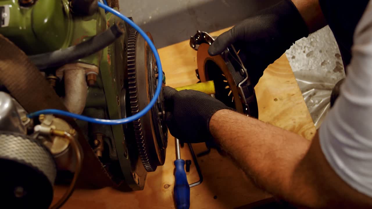 Mechanic servicing mac wheel in garage 4k