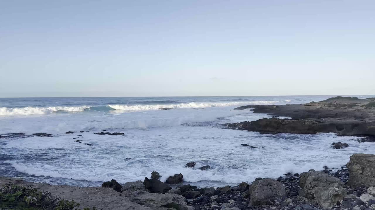 A serene evening view of the rocky coastline on Oahu, Hawaii
