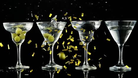 Animation-of-confetti-falling-over-cocktail-glasses-of-wine-and-olives-on-black-background