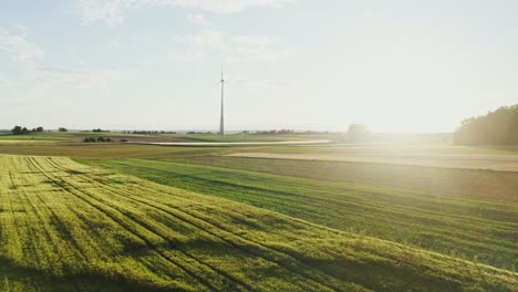 rural landscape with wind turbine at sunset