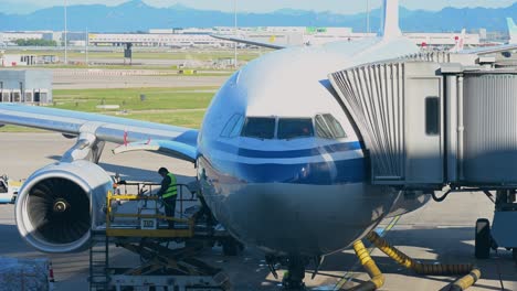 workers are seen servicing a plane stationed on the runway at beijing international airport, china, prior to its departure.