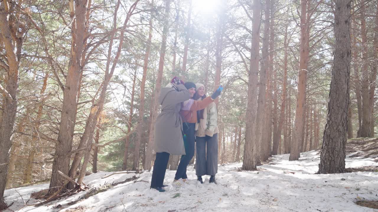 Three women in winter forest