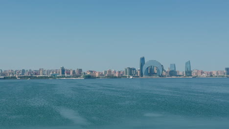 baku waterfront cityscape with crescent hotel high-rise on a sunny day