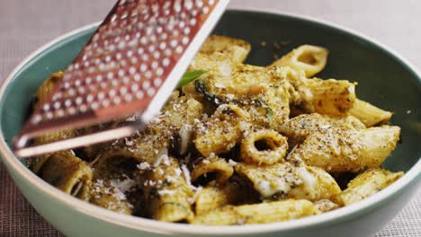 pasta de penne con pesto y parmesán