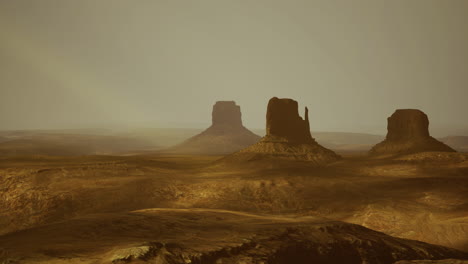 Expansive desert landscape featuring iconic rock formations at sunset