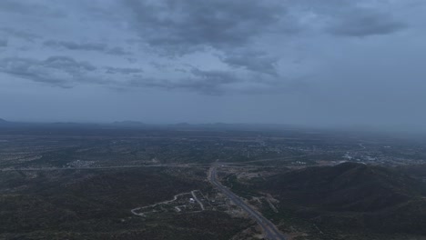 aerial-shot-of-drone-flying-over-road-or-highway-in-cloudy-day