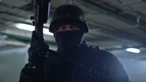 SWAT-soldier-posing-at-camera-with-assault-rifle-in-urban-building