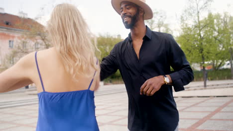 pareja interracial bailando salsa en una plaza publica 3