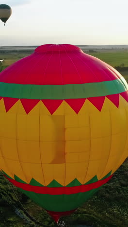 flight by hot air balloon. colorful hot air balloon flying over fields