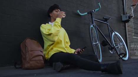 transgender adult  drinking coffee in the street