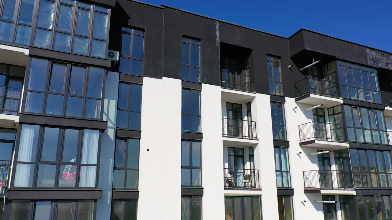 Contemporary residential building in the city. Exterior of a modern design of multistorey apartment building. Aerial view.