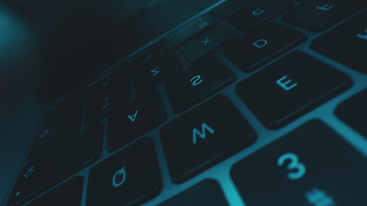 Hands Typing on a Laptop Keyboard at Night