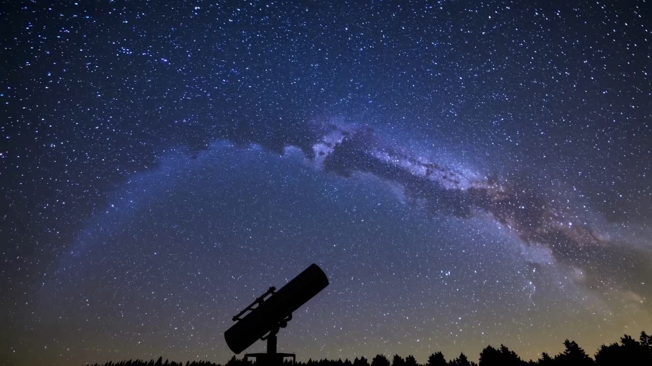 A mesmerizing time-lapse video capturing the Milky Way's arc over a silhouetted telescope