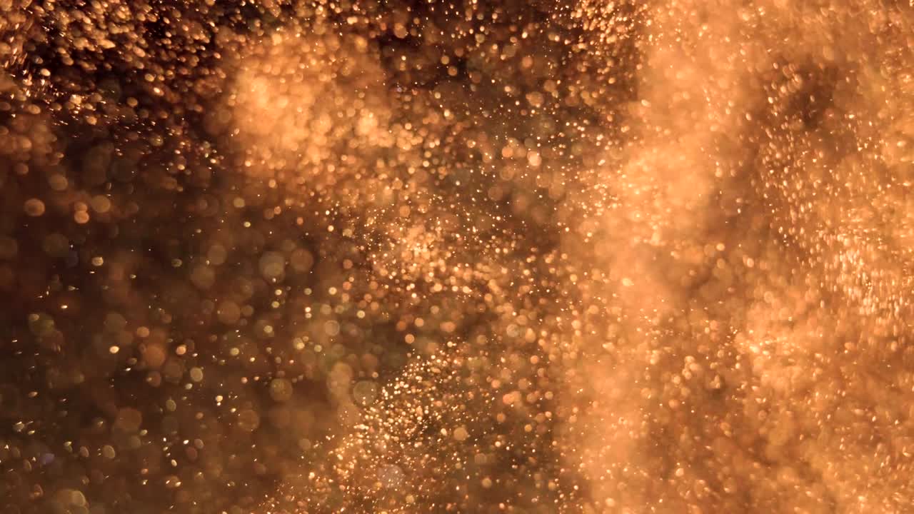 Elegant, detailed, and golden particles flow with shallow depth of field underwater