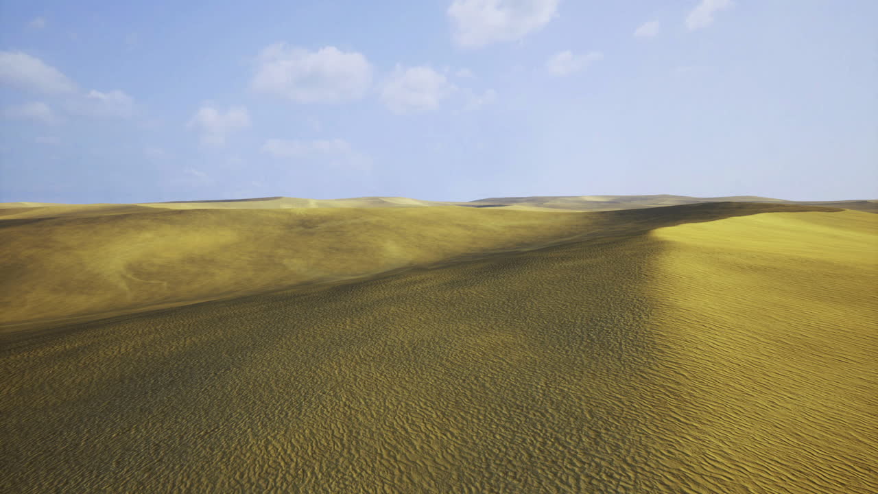 Vast golden sand dunes under clear blue sky during daytime