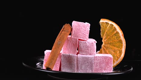 Sweet-Turkish-Delight-on-plate-with-orange-slice-and-cinnamon-stick