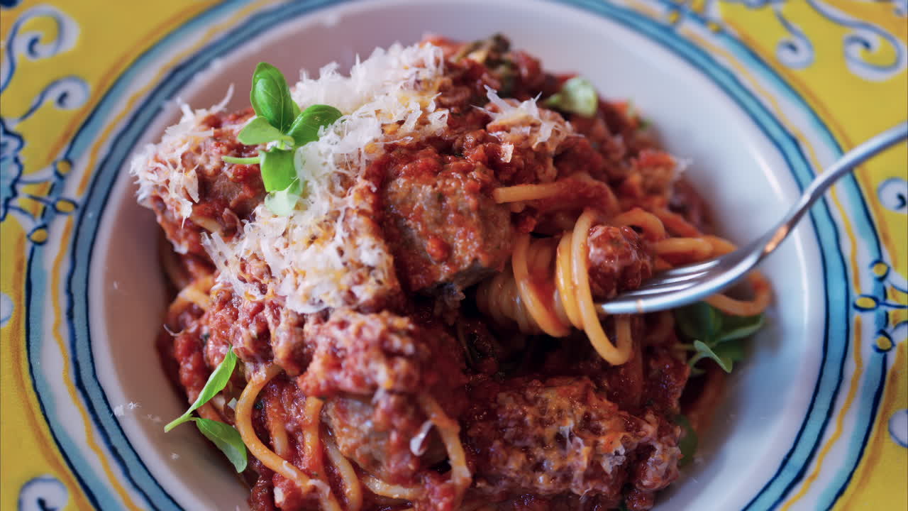 Close up of a woman eating pasta at an italian restaurant
